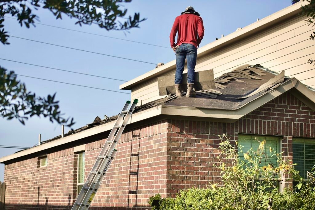 Home inspector standing on a roof during a final construction inspection
